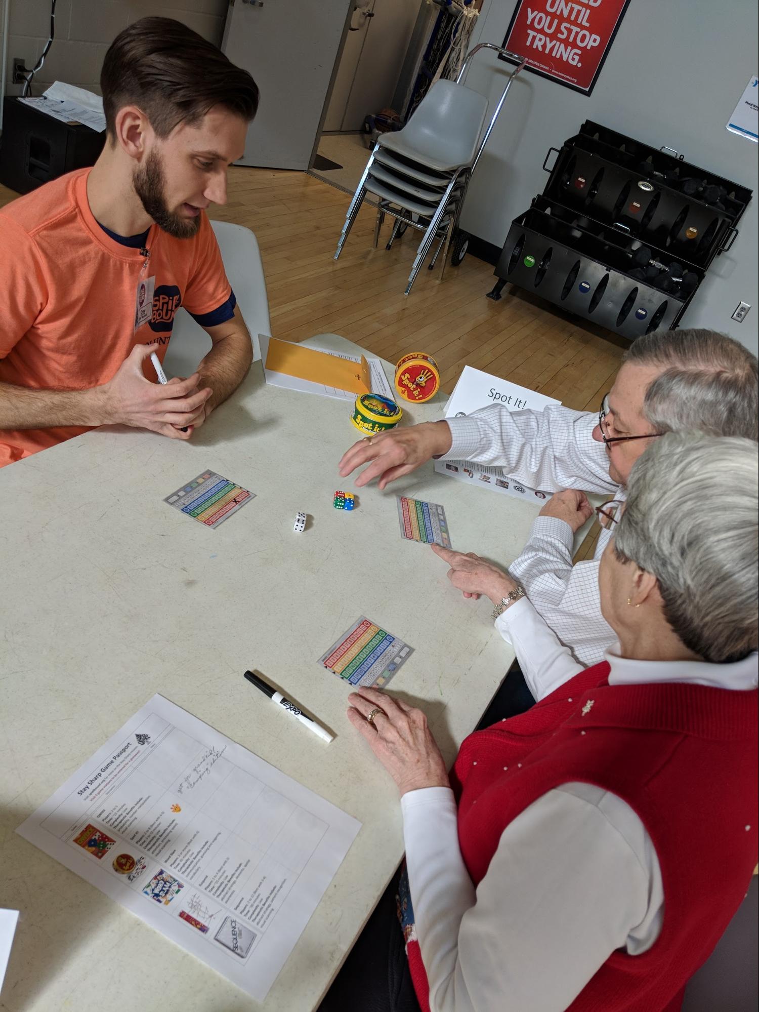 Drew Taylor teaches participants at the Amburst YMCA Qwixx