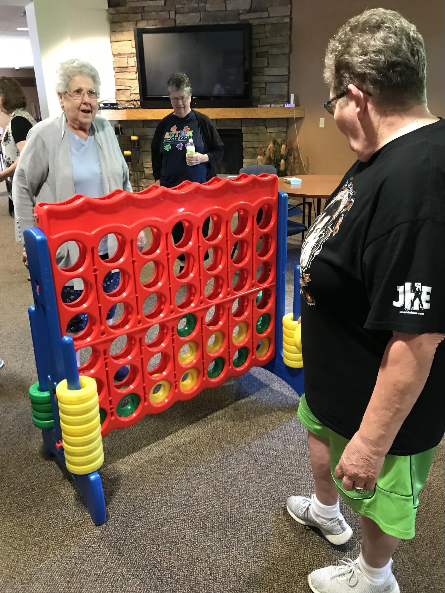 Participants at Trinity Courtyard play Spielbound's giant connect 4.