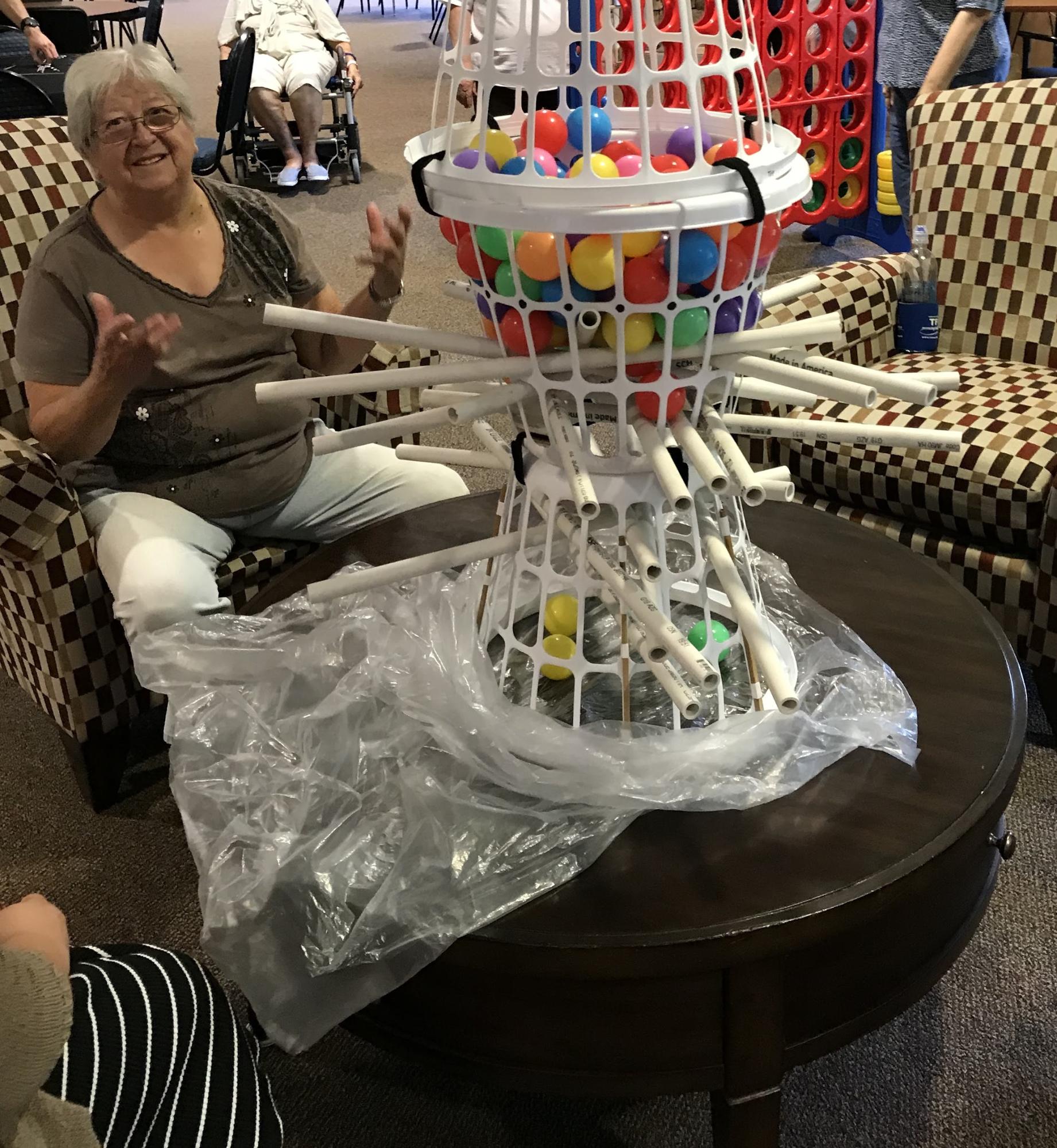 Participants at Trinity Courtyard play Stay Sharp's giant kerplunk.
